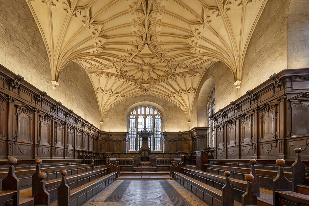 A wood-panelled room with an elaborate fanned stone ceiling