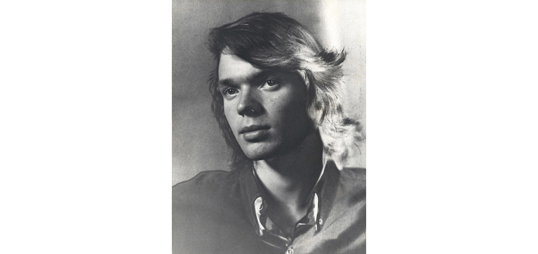 A photograph of a young man with head tilted to the right