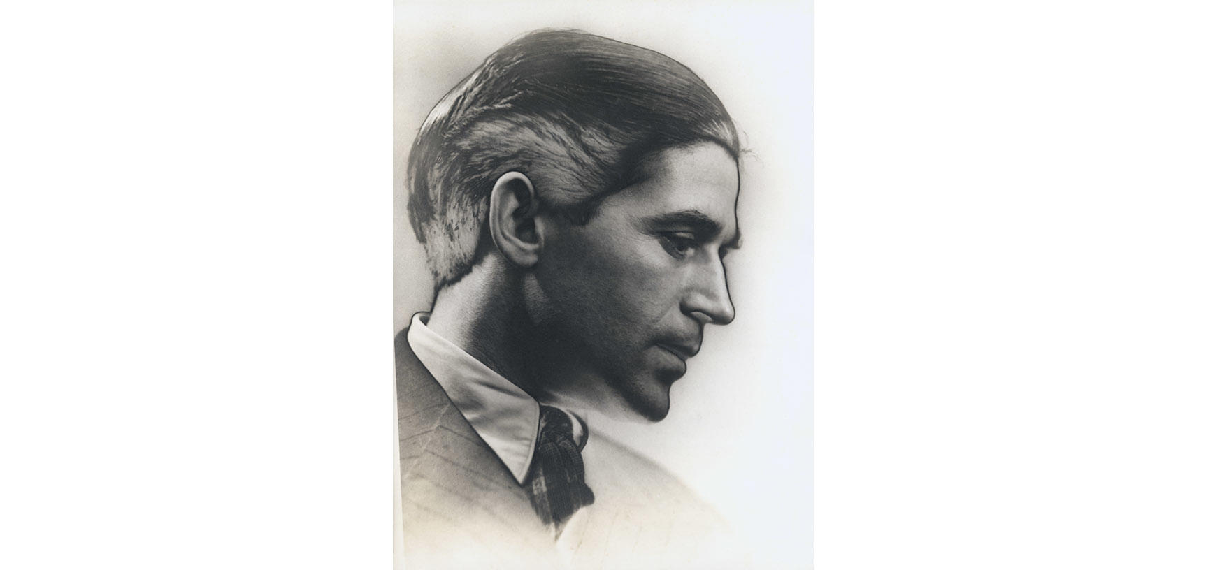 A photograph of a young man in profile