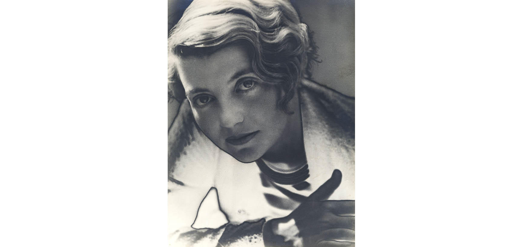 A photograph of a young woman looking directly at the camera