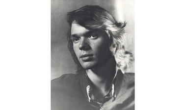 A photograph of a young man with head tilted to the right