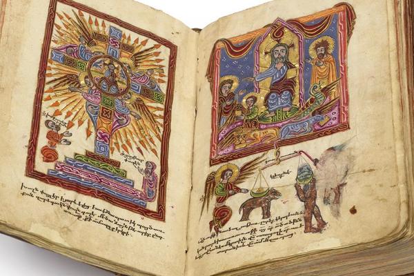 An open book with illuminated illustrations on each page